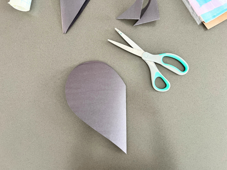 cutting heart out of black paper