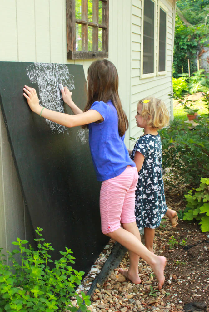 Rubbing a new homemade chalkboard with chalk