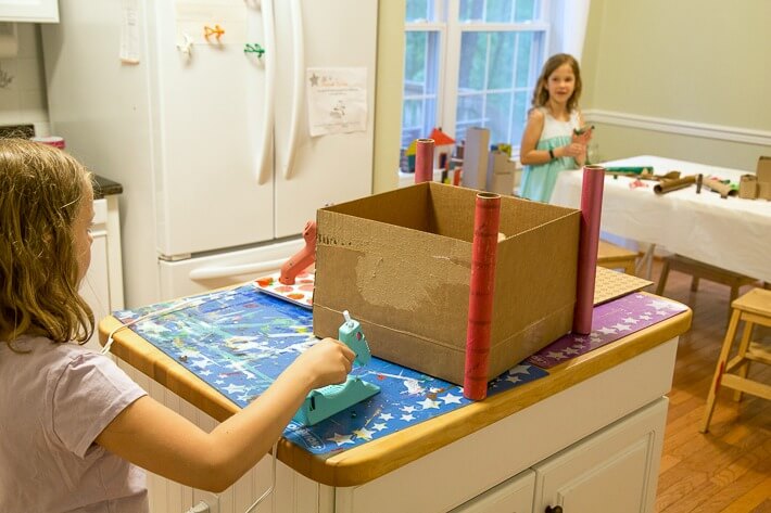 Using the glue gun to make the cardboard castle