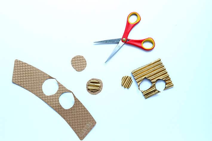 Cutting out eyes for self portrait collage