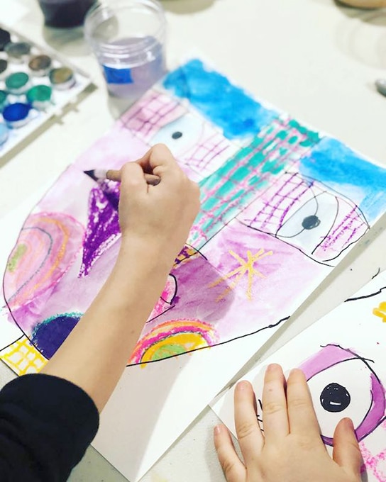 Child painting abstract portrait for kids