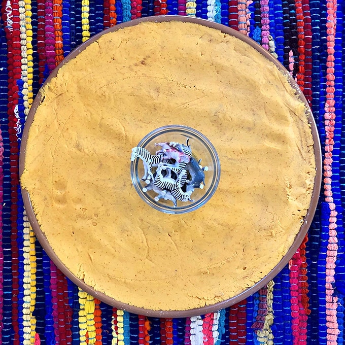 Pumpkin oobleck and mini animals for fun fall sensory play activities for toddlers.