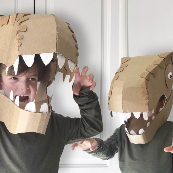 Two boys wearing cardboard dinosaur costumes from Zygote_Brown