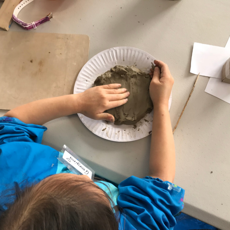 flattening clay onto plate