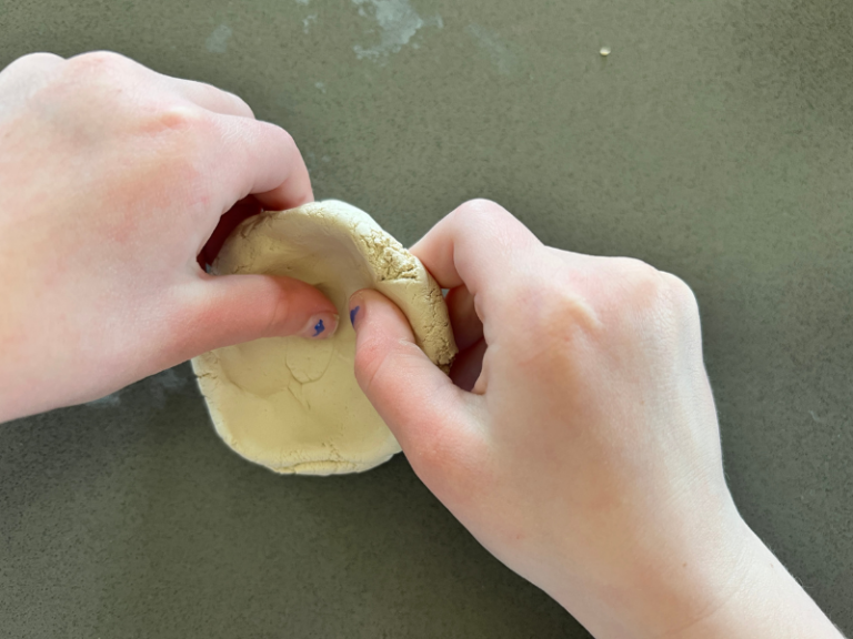 hands shaping pinch pot