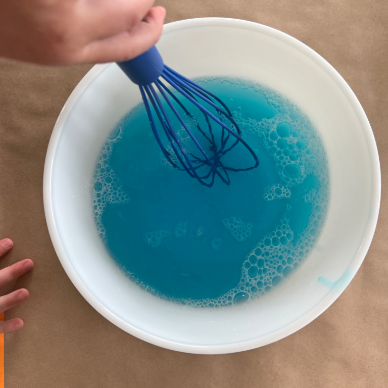 whisking dish soap into bubbles