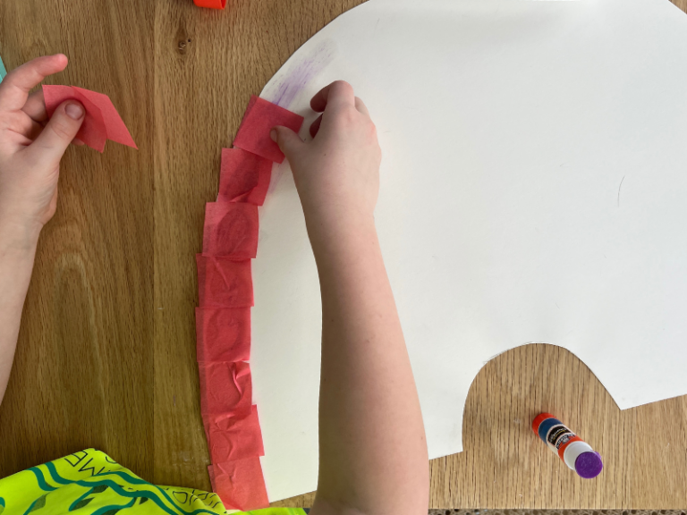 gluing tissue paper onto rainbow