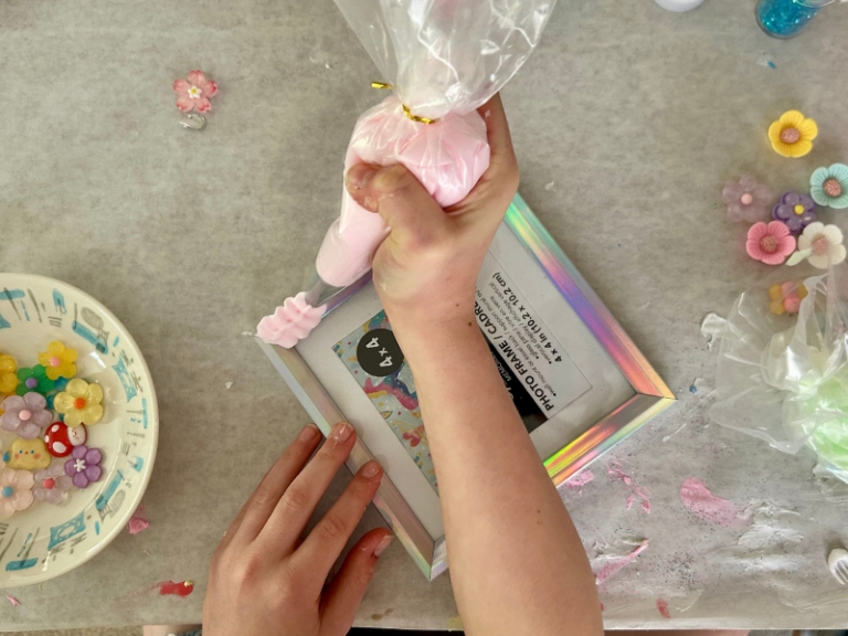 squeezing clay onto frame